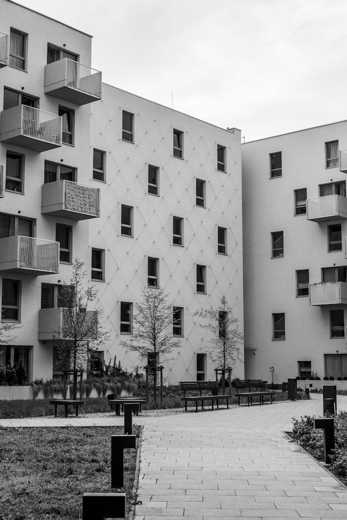 Black and white photo of modern urban apartment buildings with balconies.